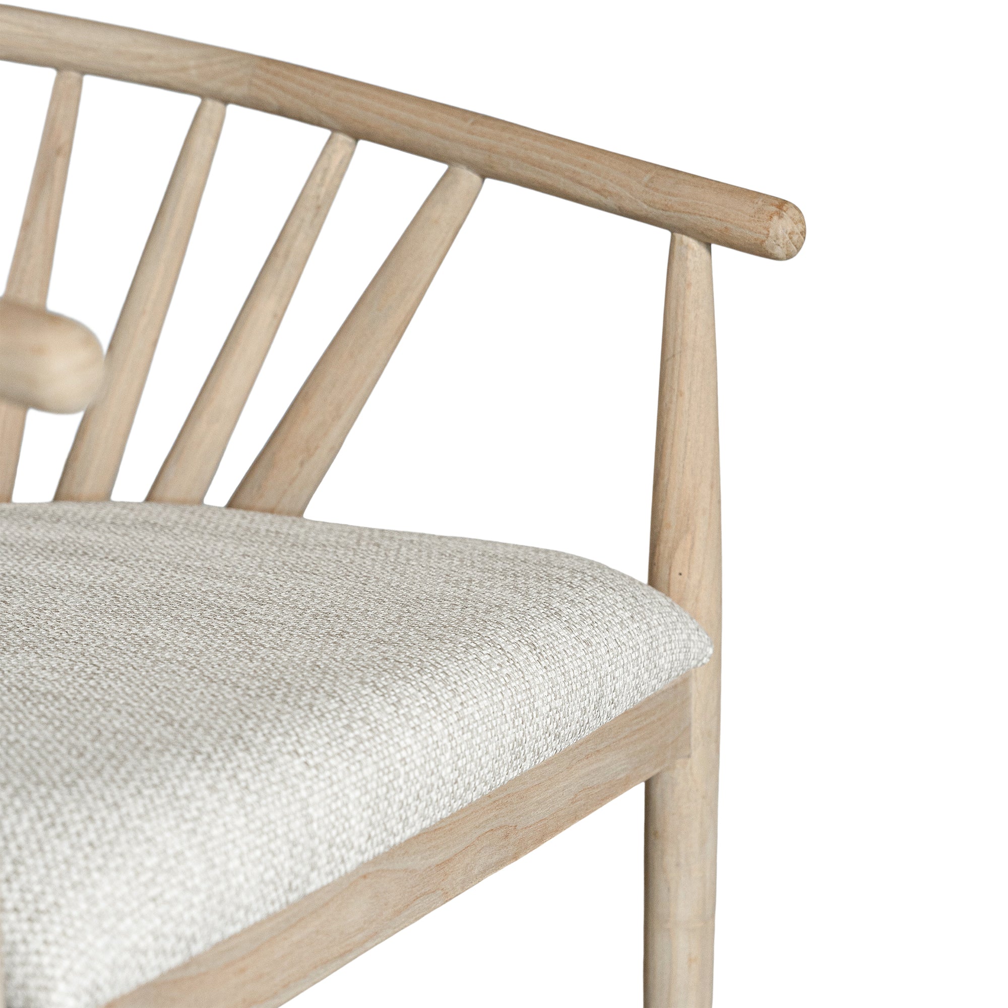 Lightwood spindle dining chair with a curved backrest and white upholstered seat, showcasing a modern yet timeless design. Crafted from solid wood, this chair brings a refined, natural aesthetic to any dining or living space