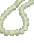 Decorative strand of recycled glass beads in a soft green hue, displayed on a minimalist black metal stand. A unique accent piece that adds texture and artisanal charm to any interior styling