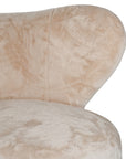 Luxurious beige teddy swivel armchair featuring a sculptural curved back and plush upholstery. A cosy and stylish accent chair designed for comfort and modern interiors