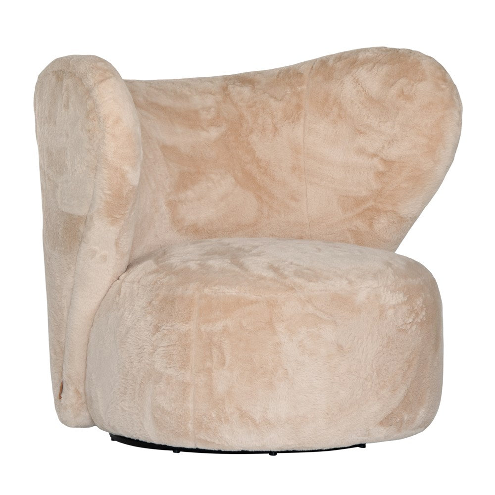 Luxurious beige teddy swivel armchair featuring a sculptural curved back and plush upholstery. A cosy and stylish accent chair designed for comfort and modern interiors