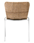 Contemporary dining chair with a sleek white metal frame and a handwoven natural rattan seat and backrest, offering a stylish and comfortable alfresco seating option