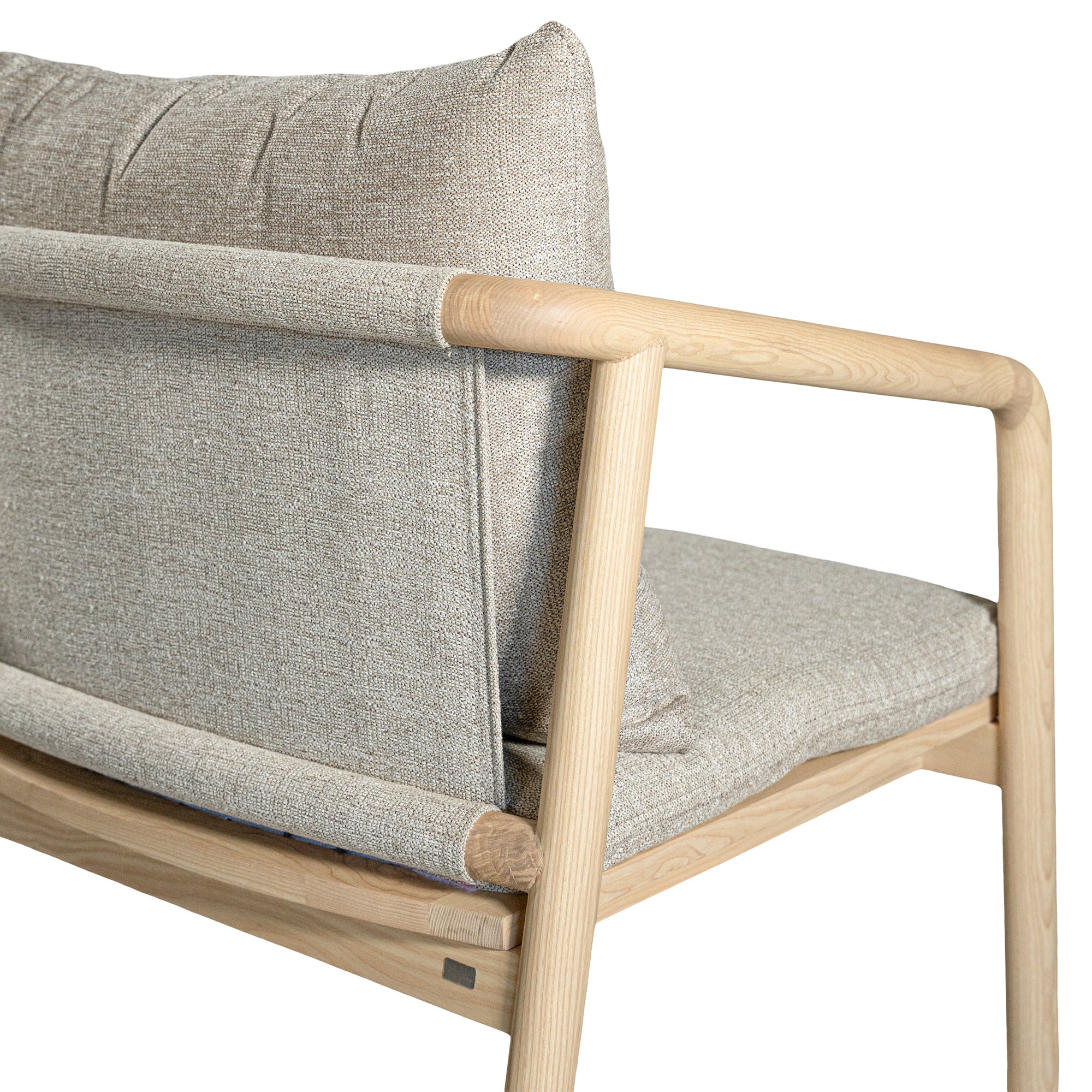 Minimalist ash armchair with natural linen cushions, featuring a sleek Scandinavian-inspired frame