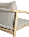 Minimalist ash armchair with natural linen cushions, featuring a sleek Scandinavian-inspired frame