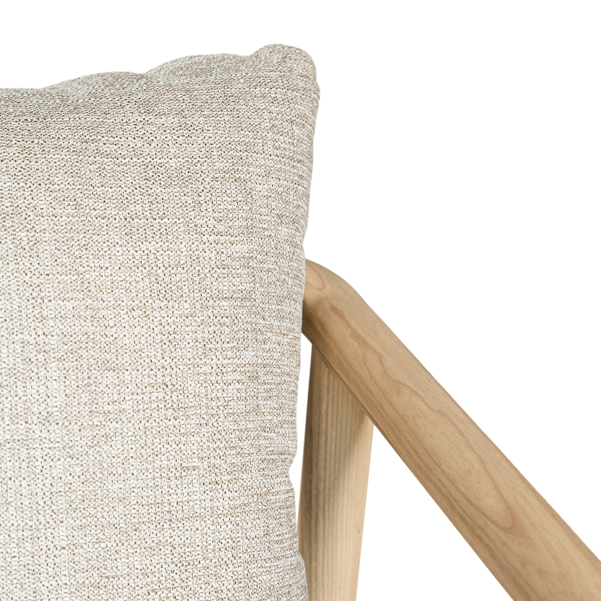 Minimalist ash armchair with natural linen cushions, featuring a sleek Scandinavian-inspired frame