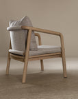 Minimalist ash armchair with natural linen cushions, featuring a sleek Scandinavian-inspired frame