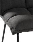 Black cushioned dining chair with a plush padded seat and high backrest, supported by a sleek black metal frame for a contemporary and comfortable seating option