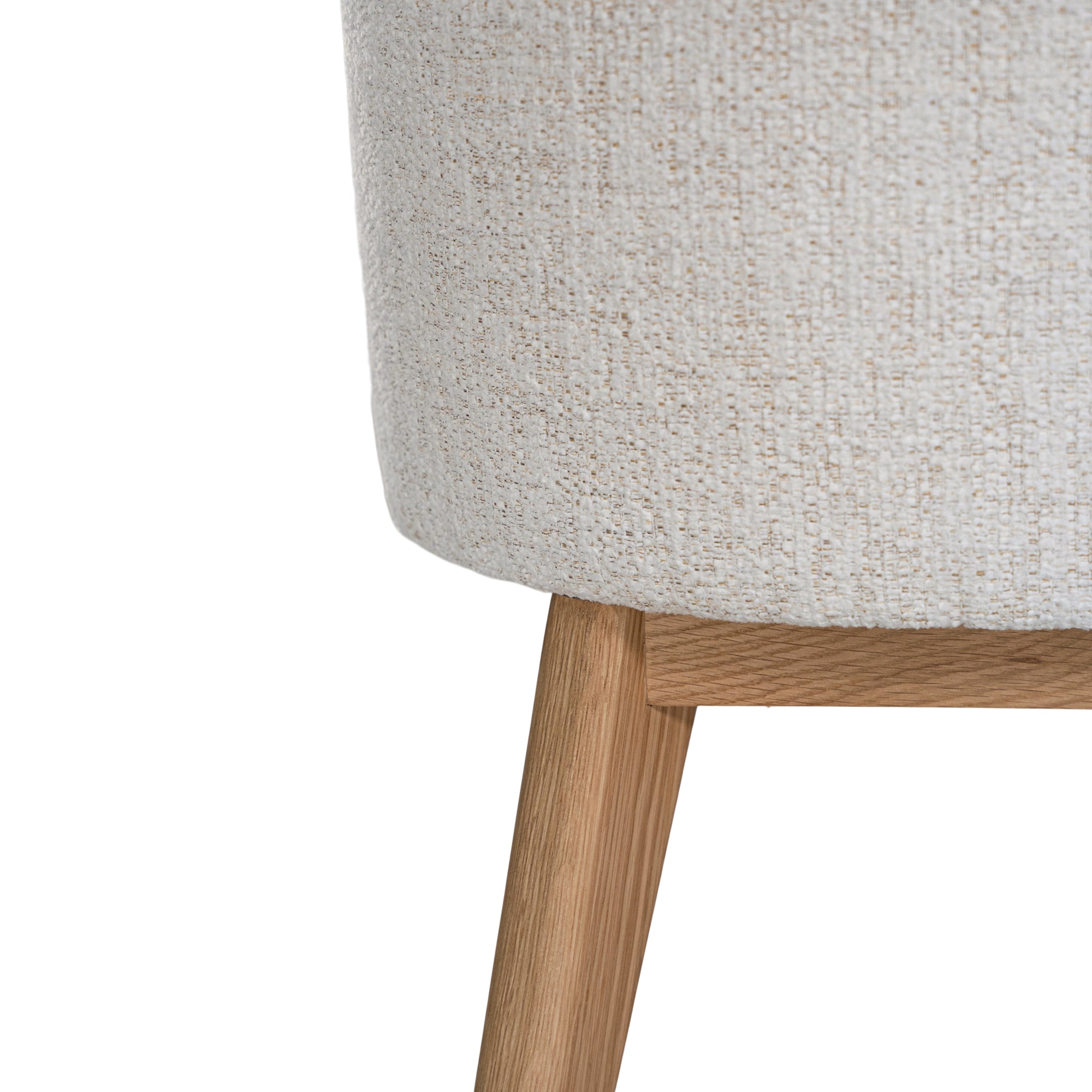 Elegant boucle dining chair with a curved upholstered backrest and plush cushioned seat, supported by tapered lightwood legs. A refined and comfortable seating option for modern dining spaces