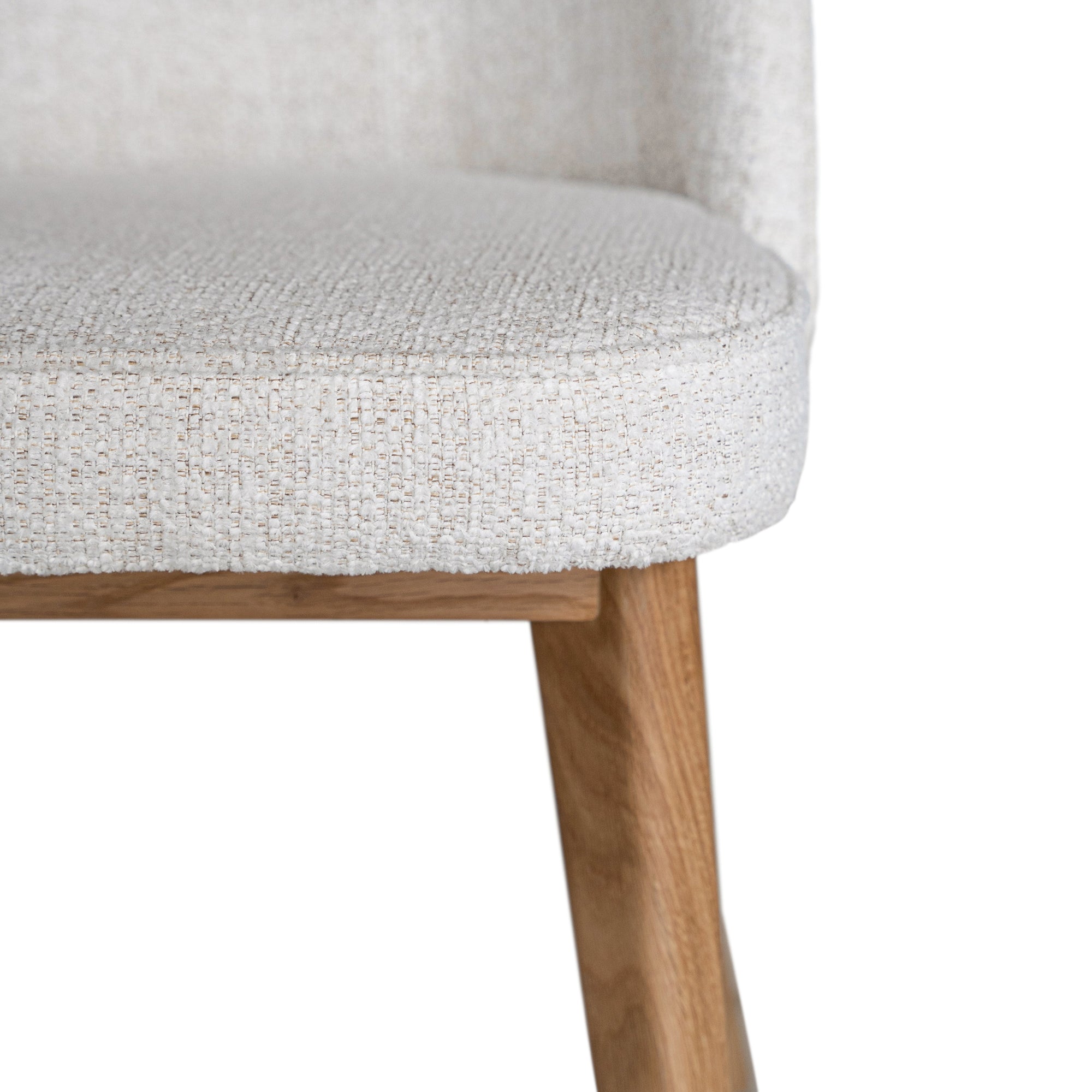 Elegant boucle dining chair with a curved upholstered backrest and plush cushioned seat, supported by tapered lightwood legs. A refined and comfortable seating option for modern dining spaces