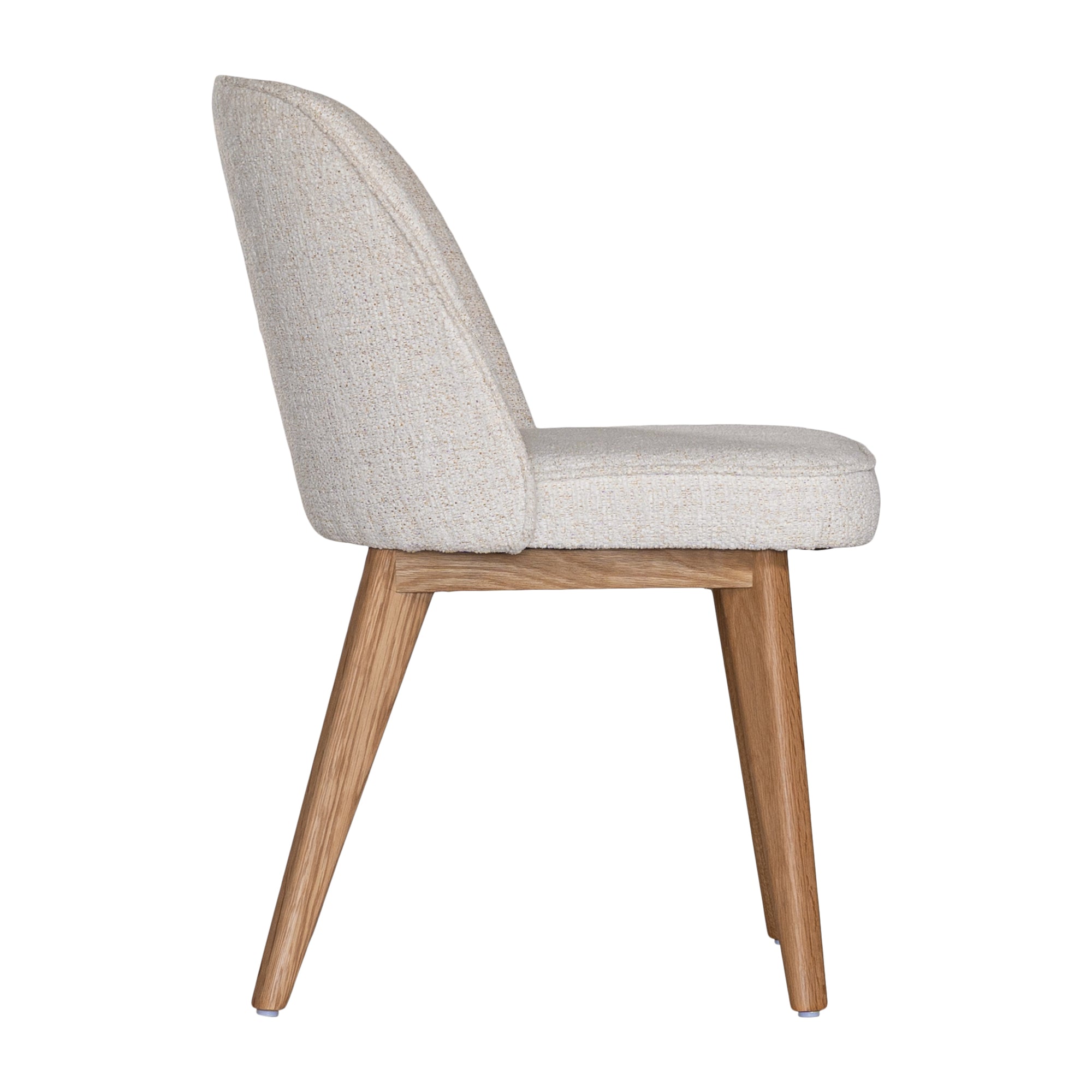 Elegant boucle dining chair with a curved upholstered backrest and plush cushioned seat, supported by tapered lightwood legs. A refined and comfortable seating option for modern dining spaces