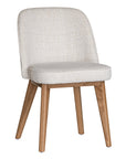 Elegant boucle dining chair with a curved upholstered backrest and plush cushioned seat, supported by tapered lightwood legs. A refined and comfortable seating option for modern dining spaces