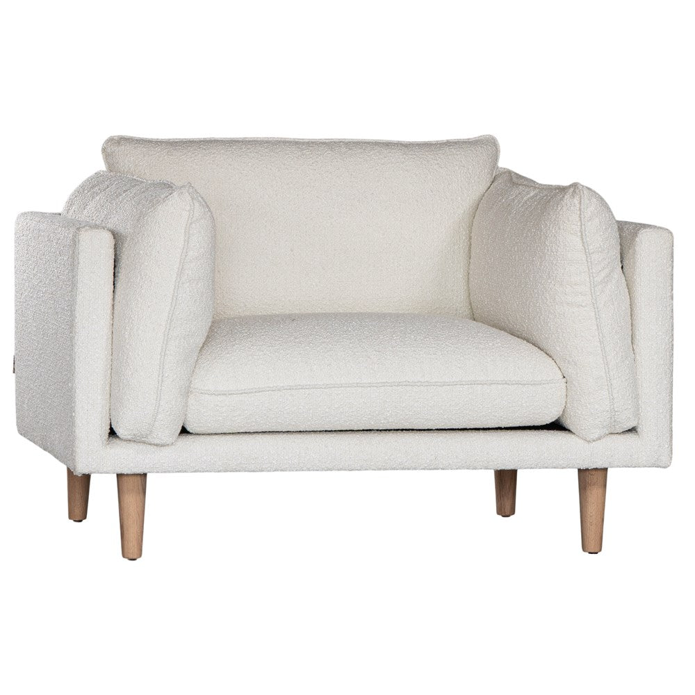 A luxurious white boucle armchair from KULALA Living, featuring plush cushioning and natural timber legs. A contemporary and stylish seating option designed for comfort and modern interiors