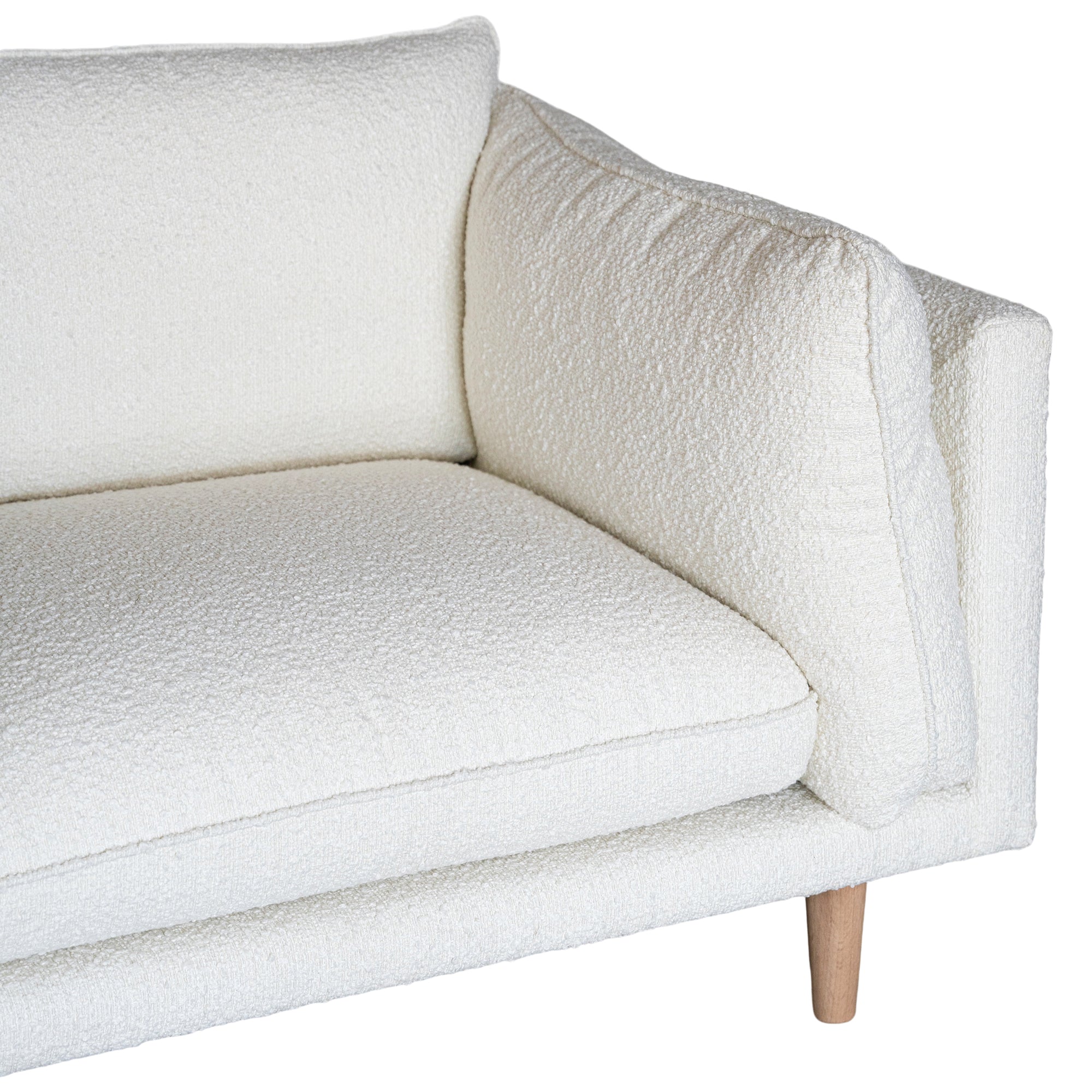 A modern white boucle sofa from KULALA Living, designed with plush cushioning and natural timber legs. A statement piece for contemporary interiors, offering both style and comfort