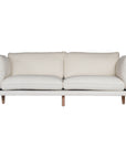 A modern white boucle sofa from KULALA Living, designed with plush cushioning and natural timber legs. A statement piece for contemporary interiors, offering both style and comfort