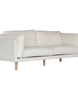 A modern white boucle sofa from KULALA Living, designed with plush cushioning and natural timber legs. A statement piece for contemporary interiors, offering both style and comfort