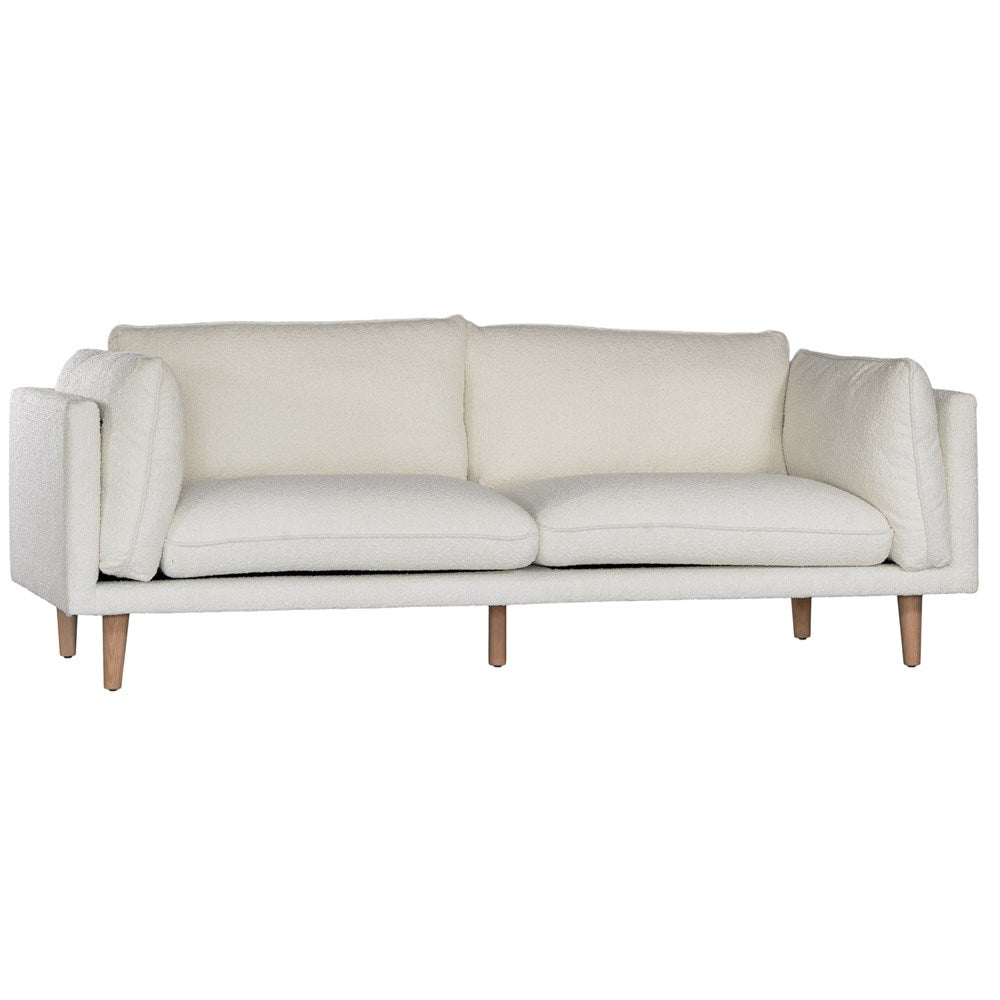 A modern white boucle sofa from KULALA Living, designed with plush cushioning and natural timber legs. A statement piece for contemporary interiors, offering both style and comfort