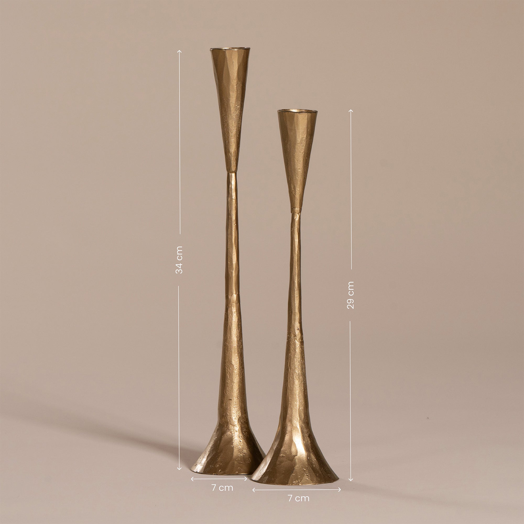 Set of two handcrafted brass candlesticks with a slender, flared silhouette and hammered texture, displayed against a neutral background