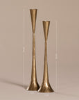 Set of two handcrafted brass candlesticks with a slender, flared silhouette and hammered texture, displayed against a neutral background