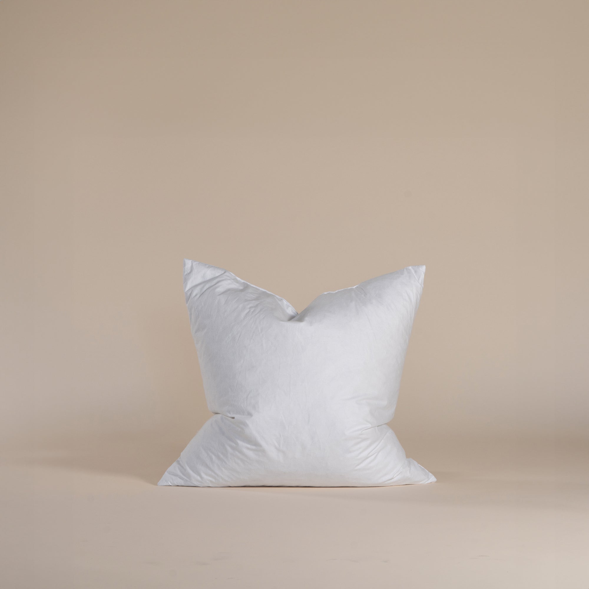 A plush feather-filled cushion insert in a crisp white cover, designed to provide soft yet supportive comfort. Perfect for enhancing the shape and feel of decorative cushions.