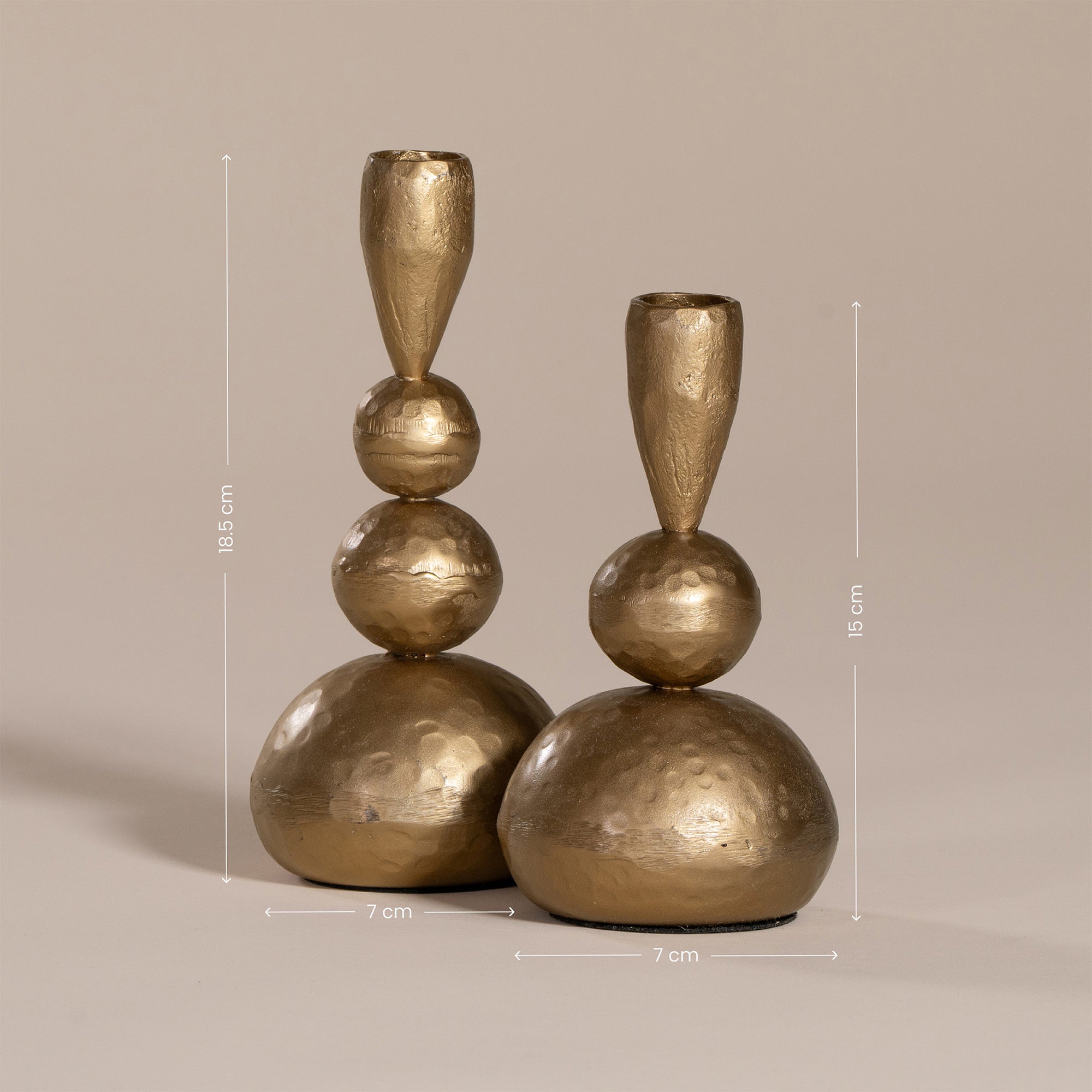 Set of gold sculptural candlesticks with a hammered brass finish, featuring organic stacked spheres for a unique, artisanal look