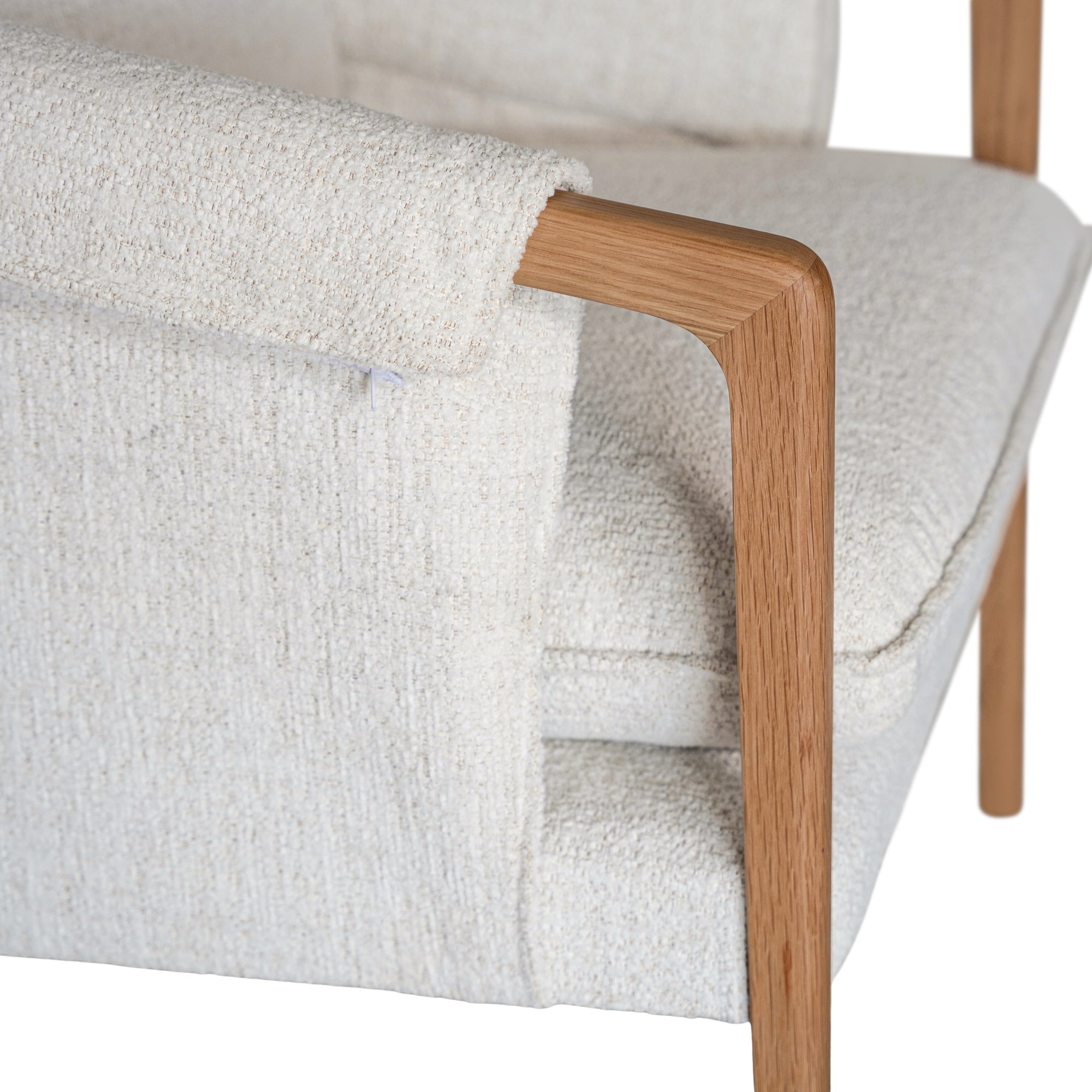 A sophisticated Hamptons-style armchair from KULALA Living, featuring a natural oak frame and soft linen upholstery in a neutral hue. Designed for both comfort and elegance, perfect for contemporary and coastal interiors