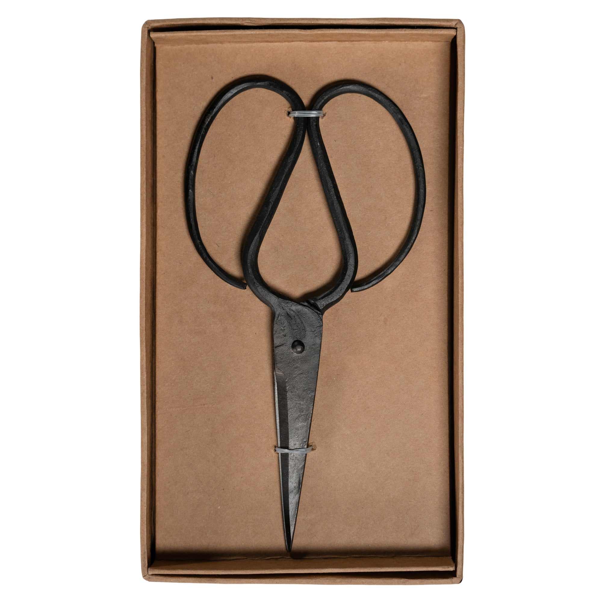 A pair of handcrafted black iron scissors with a vintage-inspired design, presented in a minimalist brown cardboard box