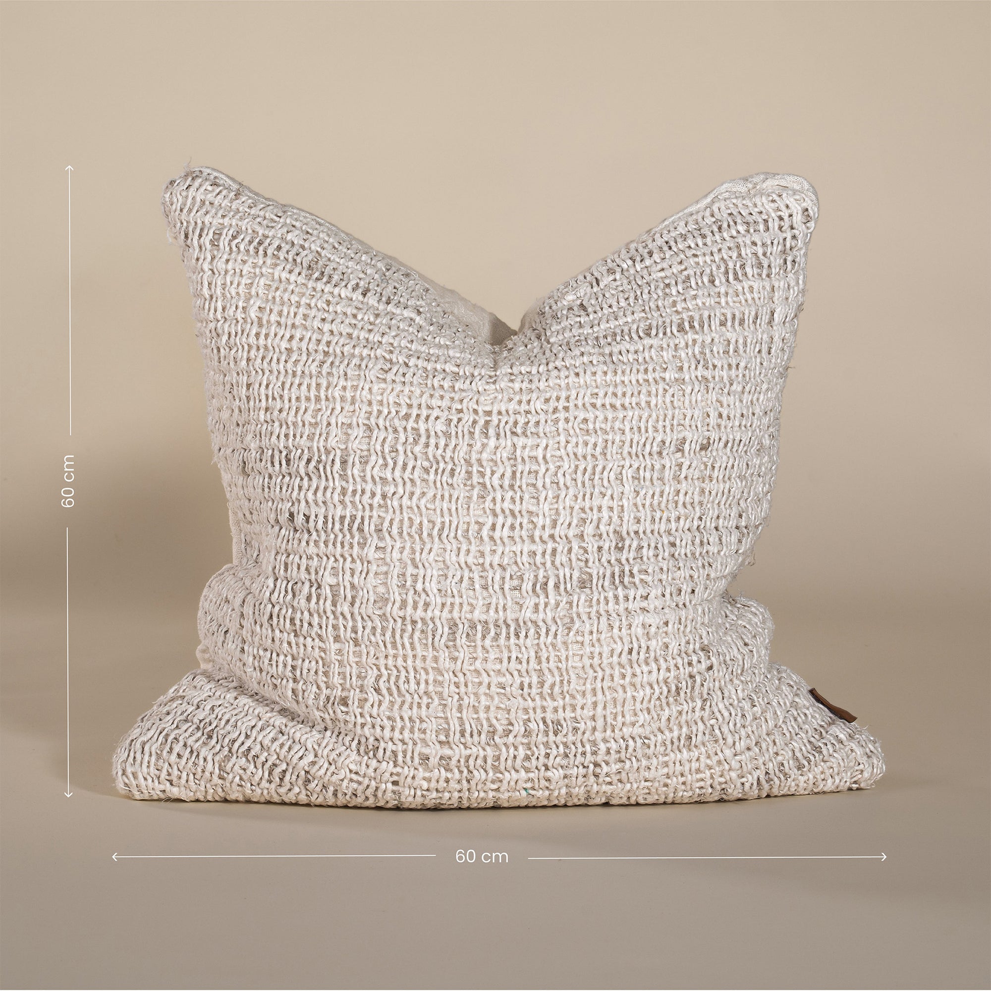 Handwoven cushion cover in a natural tone, measuring 60cm x 60cm, with an organic textured weave, perfect for relaxed and stylish interiors