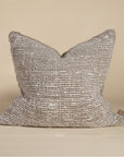 Handwoven cushion cover in earthy tones with a rich, organic texture, perfect for adding warmth to any space