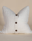 Handcrafted linen cushion in a soft cream hue, featuring a textured woven centre panel for a rustic yet refined aesthetic