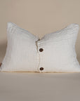 Handwoven linen cushion in a soft cream shade, featuring a button closure for a timeless and artisanal touch