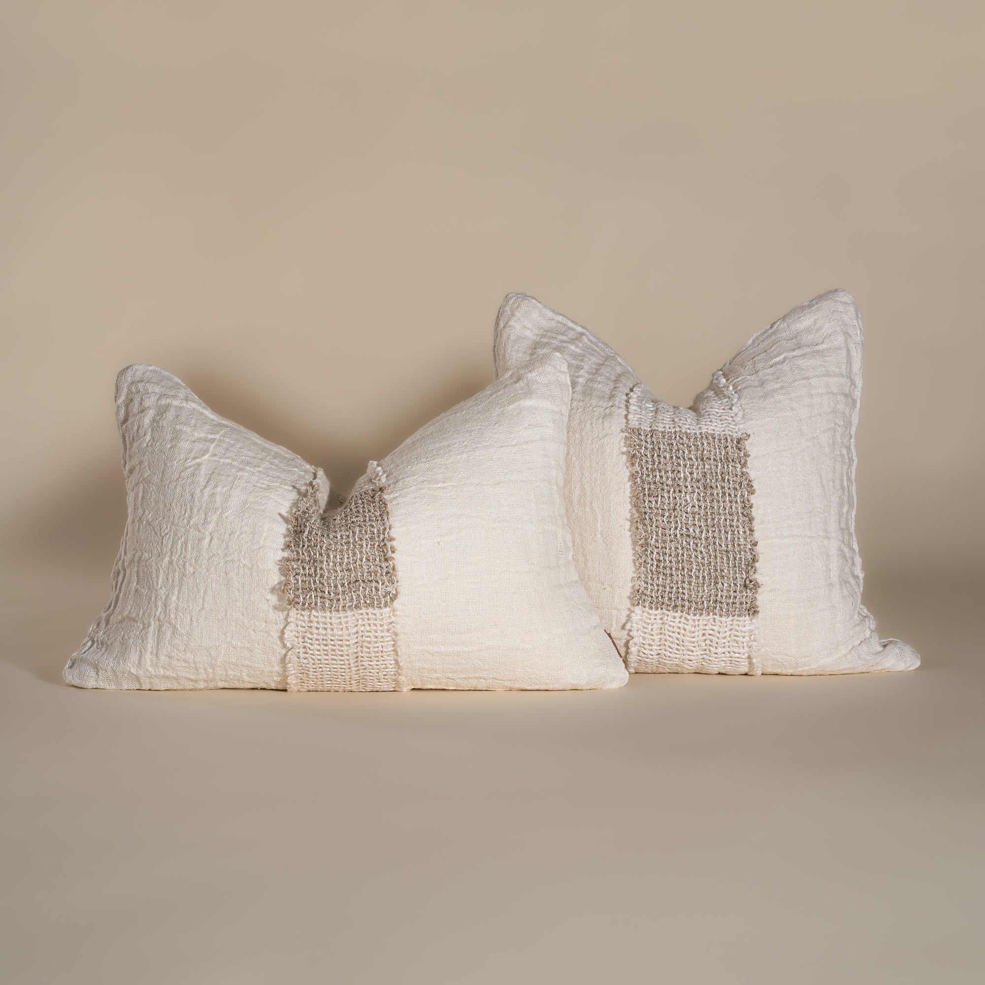 Handcrafted linen cushion in a soft cream hue, featuring a textured woven centre panel for a rustic yet refined aesthetic