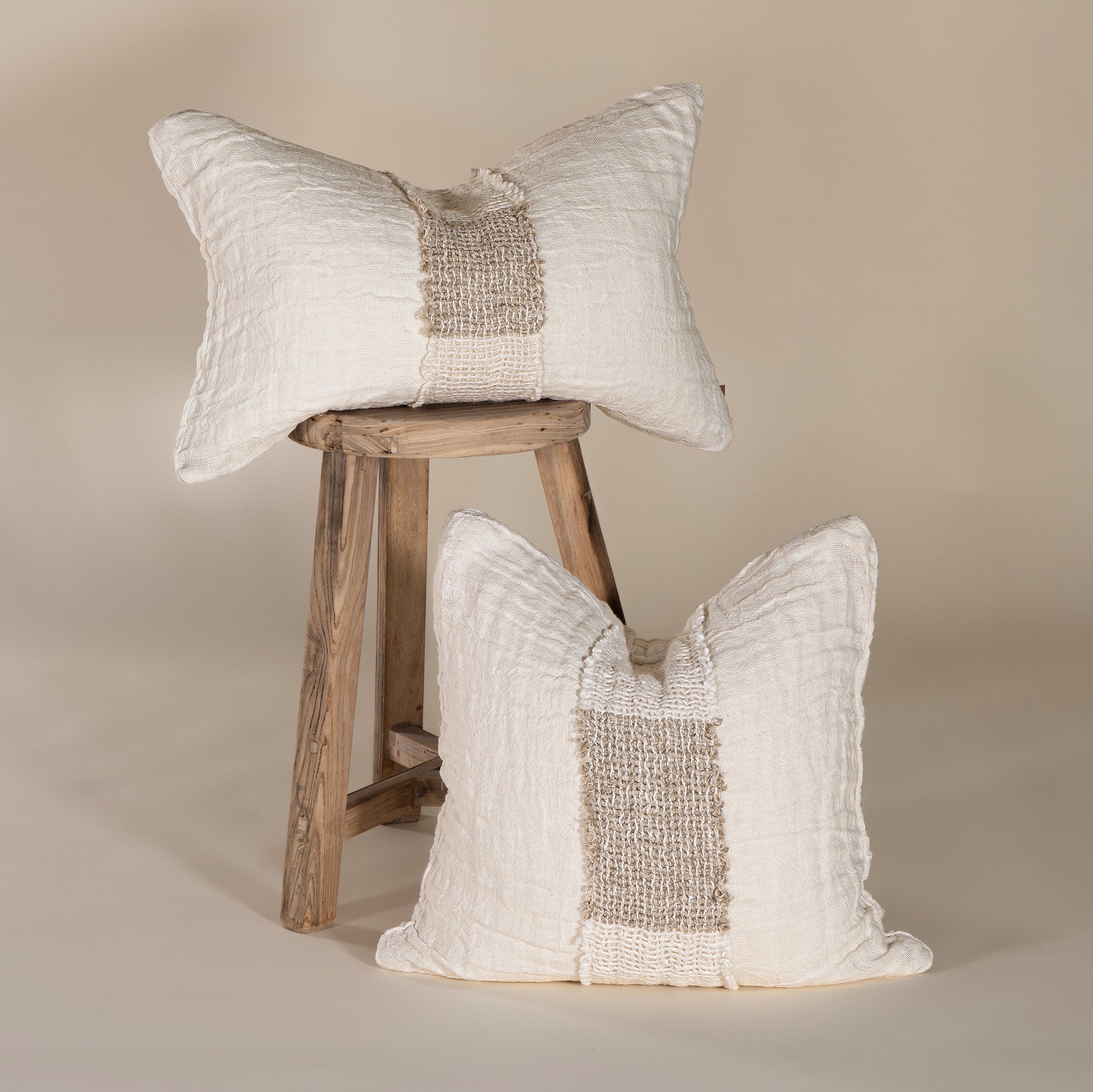 Handcrafted linen cushion in a soft cream hue, featuring a textured woven centre panel for a rustic yet refined aesthetic