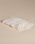 An elegant off-white handwoven linen towel from KULALA Living, featuring a soft texture and delicate fringed edges. A perfect layering piece for a relaxed, stylish home