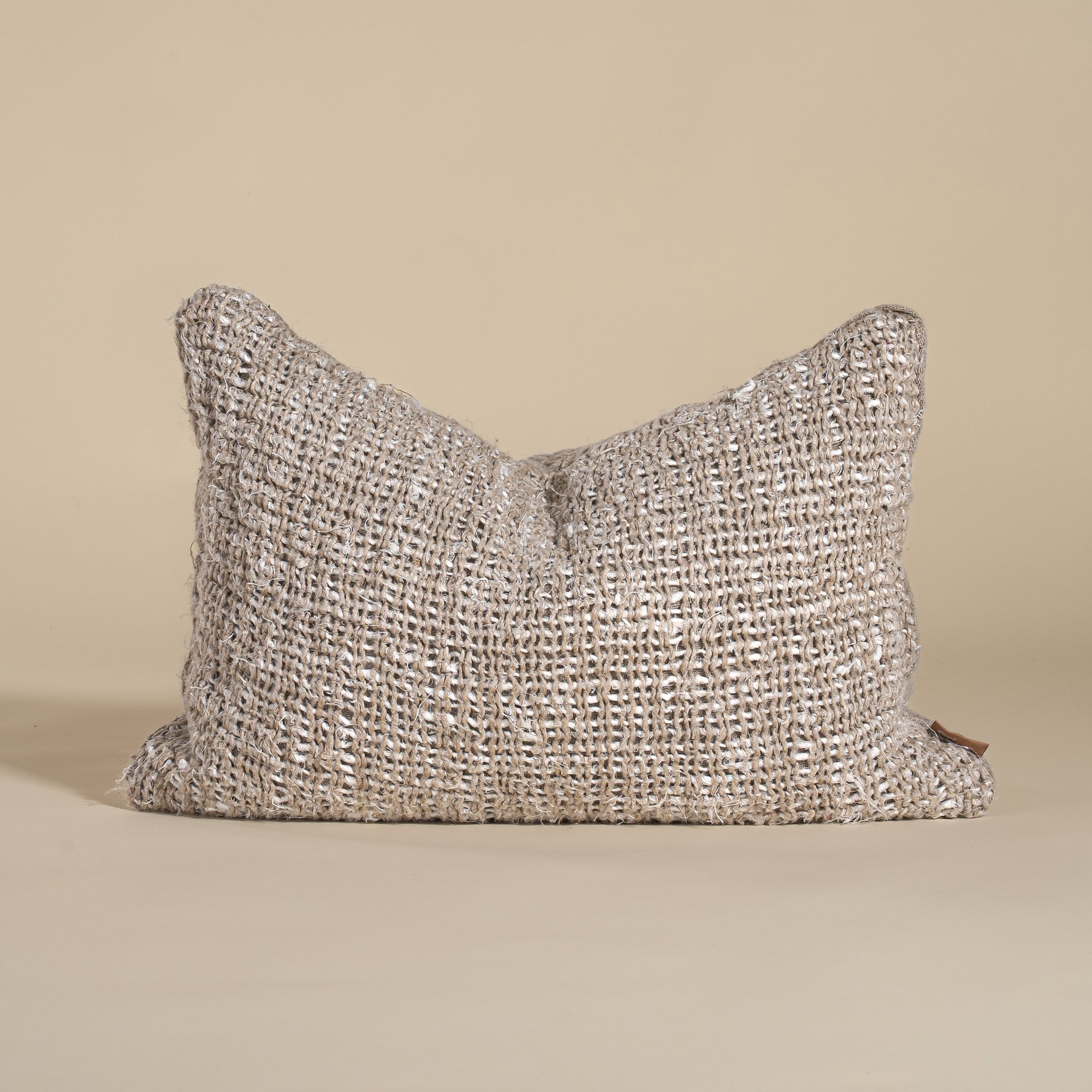 Handwoven lumbar cushion in a natural earthy tone, featuring a rich, textured weave that adds warmth and character to any living space