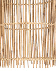 Tall handwoven rattan pendant light with an open lattice design, offering natural texture and airy illumination for contemporary interiors