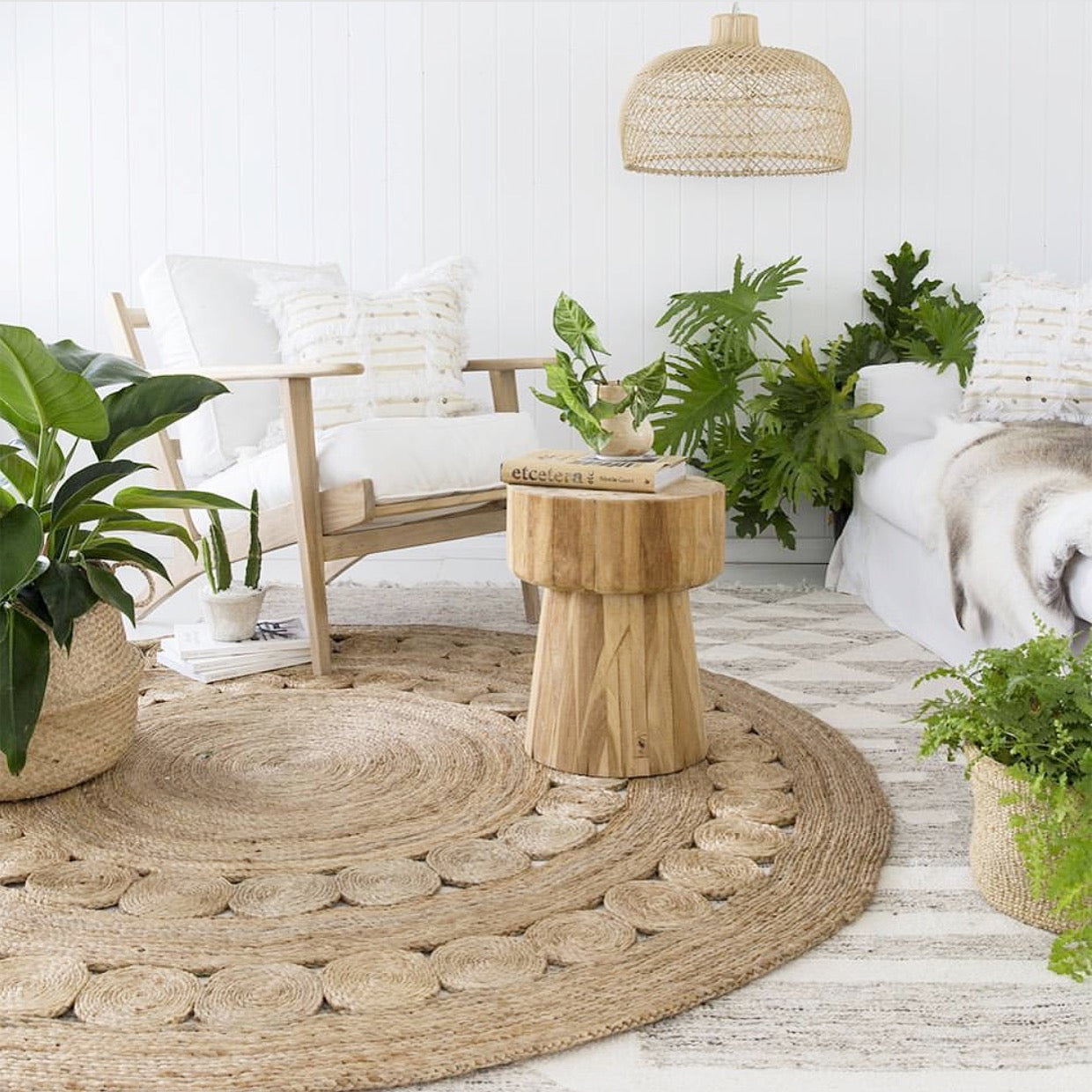 Tranquil lounge space featuring a handcrafted teak side table, woven jute rug, and natural-toned furniture, creating a relaxed and organic atmosphere