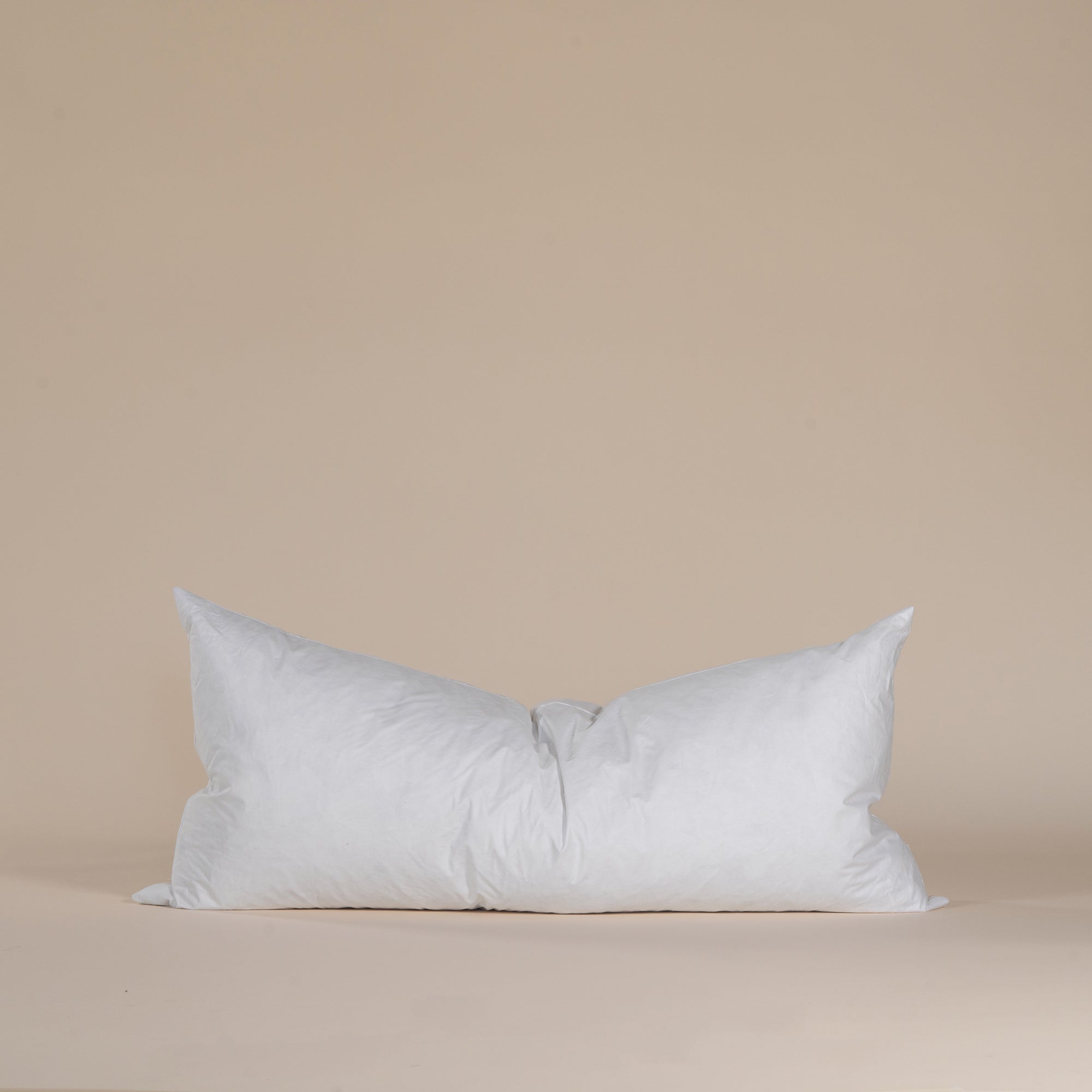 A white lumbar cushion insert designed for ultimate comfort and support, featuring a soft cotton cover and plush filling. Perfect for pairing with decorative cushion covers.