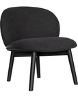 Contemporary black lounge chair with a curved backrest and plush cushioning, supported by sleek black timber legs