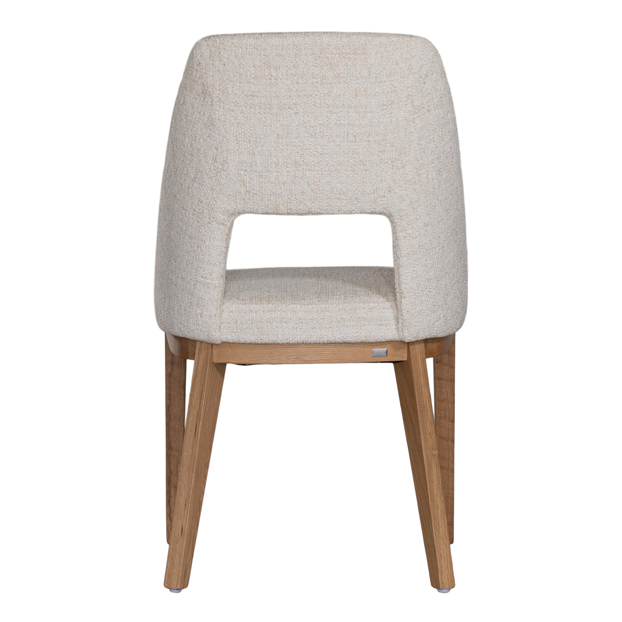 A contemporary dining chair from KULALA Living, featuring soft boucle upholstery and sturdy natural timber legs. Designed for comfort and style, perfect for modern dining spaces