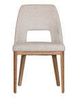 A contemporary dining chair from KULALA Living, featuring soft boucle upholstery and sturdy natural timber legs. Designed for comfort and style, perfect for modern dining spaces