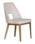 A contemporary dining chair from KULALA Living, featuring soft boucle upholstery and sturdy natural timber legs. Designed for comfort and style, perfect for modern dining spaces