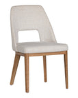 A contemporary dining chair from KULALA Living, featuring soft boucle upholstery and sturdy natural timber legs. Designed for comfort and style, perfect for modern dining spaces