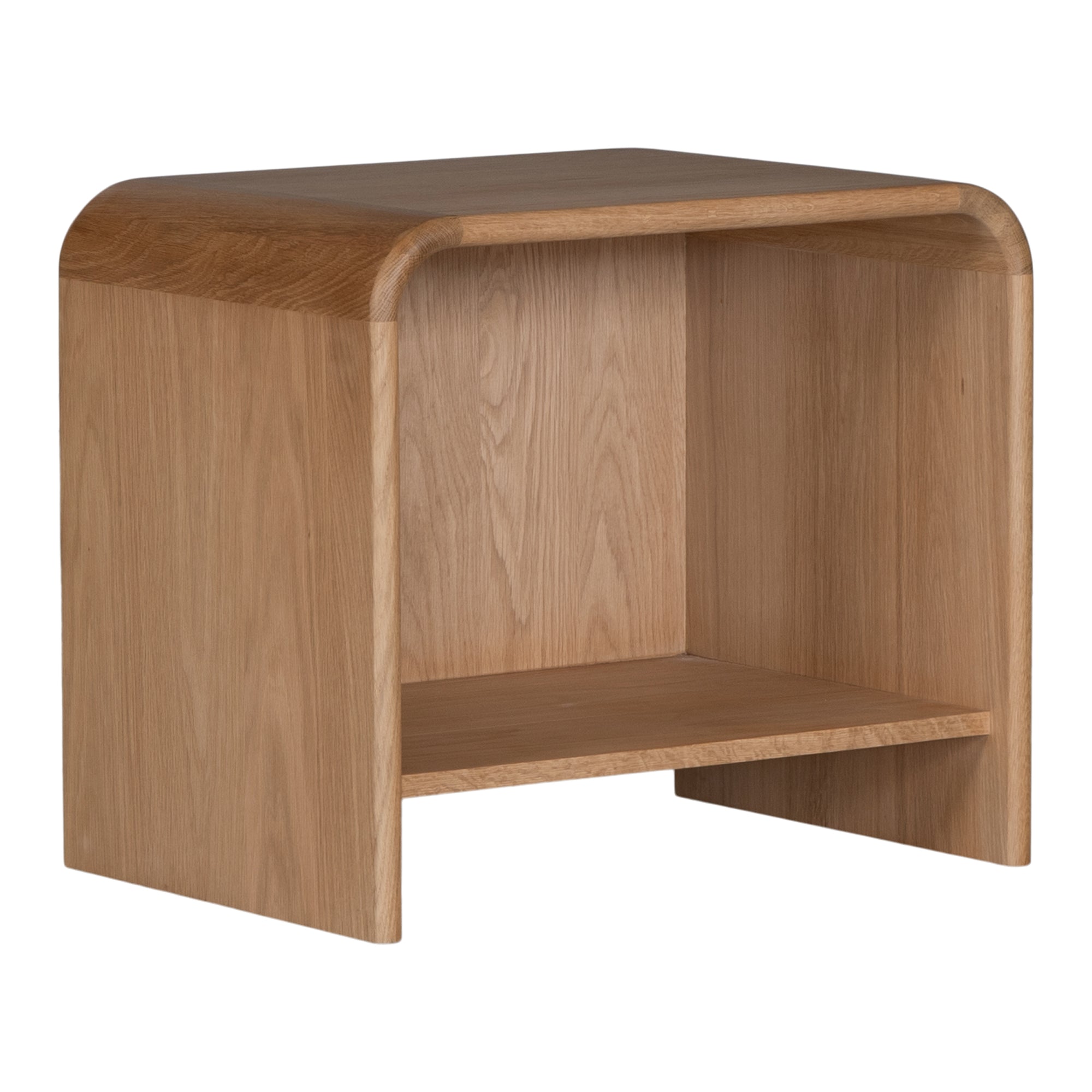 A modern oak bedside table from KULALA Living, featuring a curved silhouette and open storage shelf. Crafted from natural wood, this minimalist piece enhances any bedroom with its warm, organic aesthetic