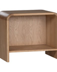 A modern oak bedside table from KULALA Living, featuring a curved silhouette and open storage shelf. Crafted from natural wood, this minimalist piece enhances any bedroom with its warm, organic aesthetic