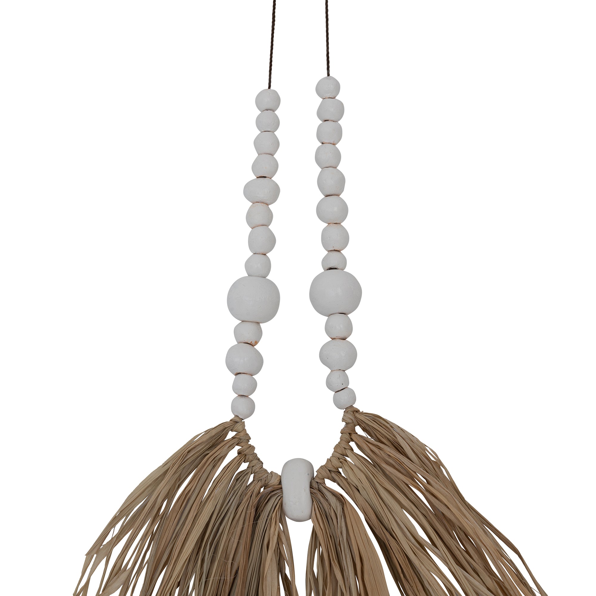 Decorative raffia and shell necklace on a black stand, featuring white wooden beads and natural raffia fringe, ideal for coastal and bohemian interiors