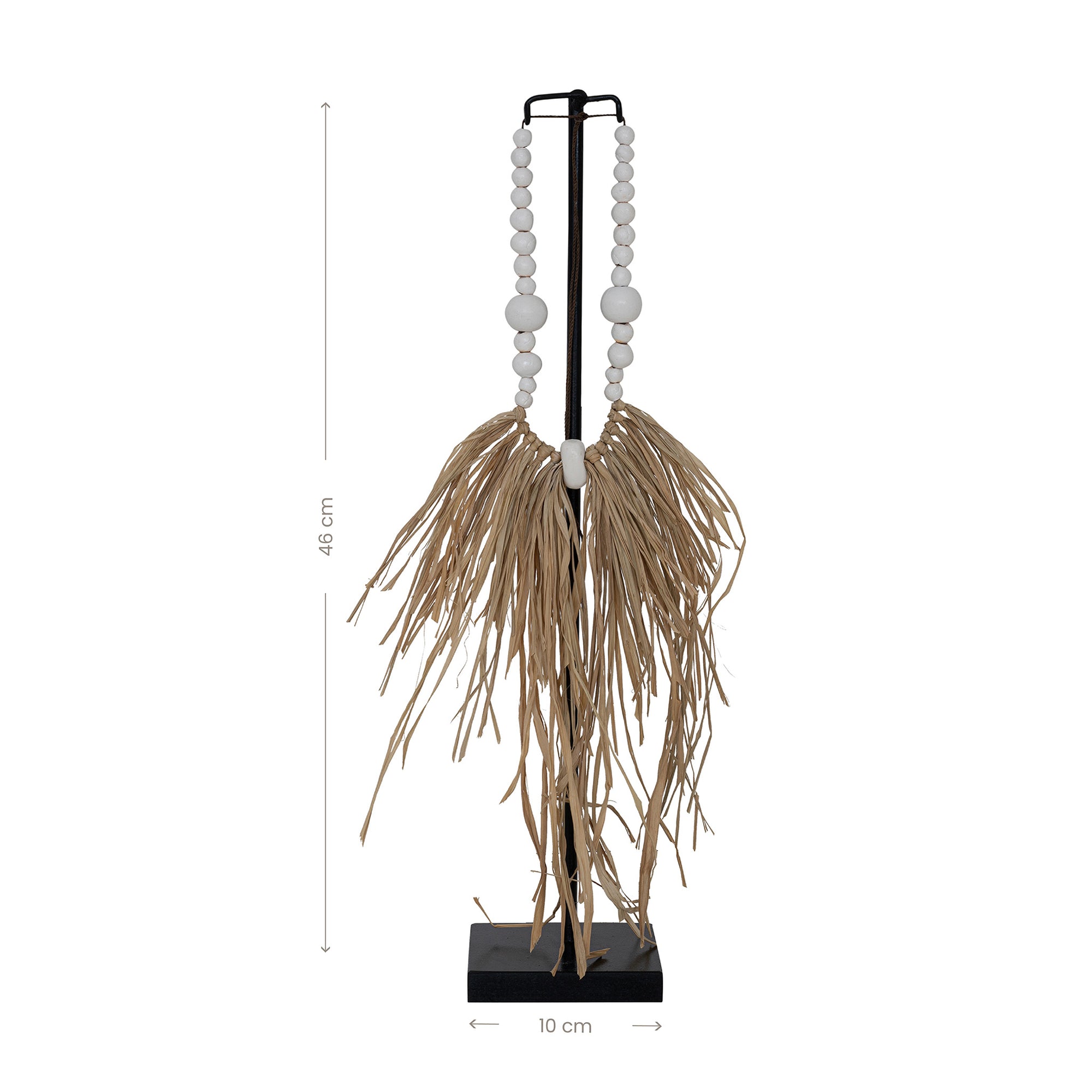 Decorative raffia and shell necklace on a black stand, featuring white wooden beads and natural raffia fringe, ideal for coastal and bohemian interiors