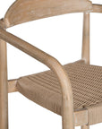 Dining chair featuring a natural wood frame with a curved backrest and a handwoven rope seat, offering a blend of comfort and organic elegance