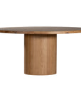 Contemporary round oak pedestal dining table featuring a sleek, minimalist design with a solid cylindrical base and smooth tabletop