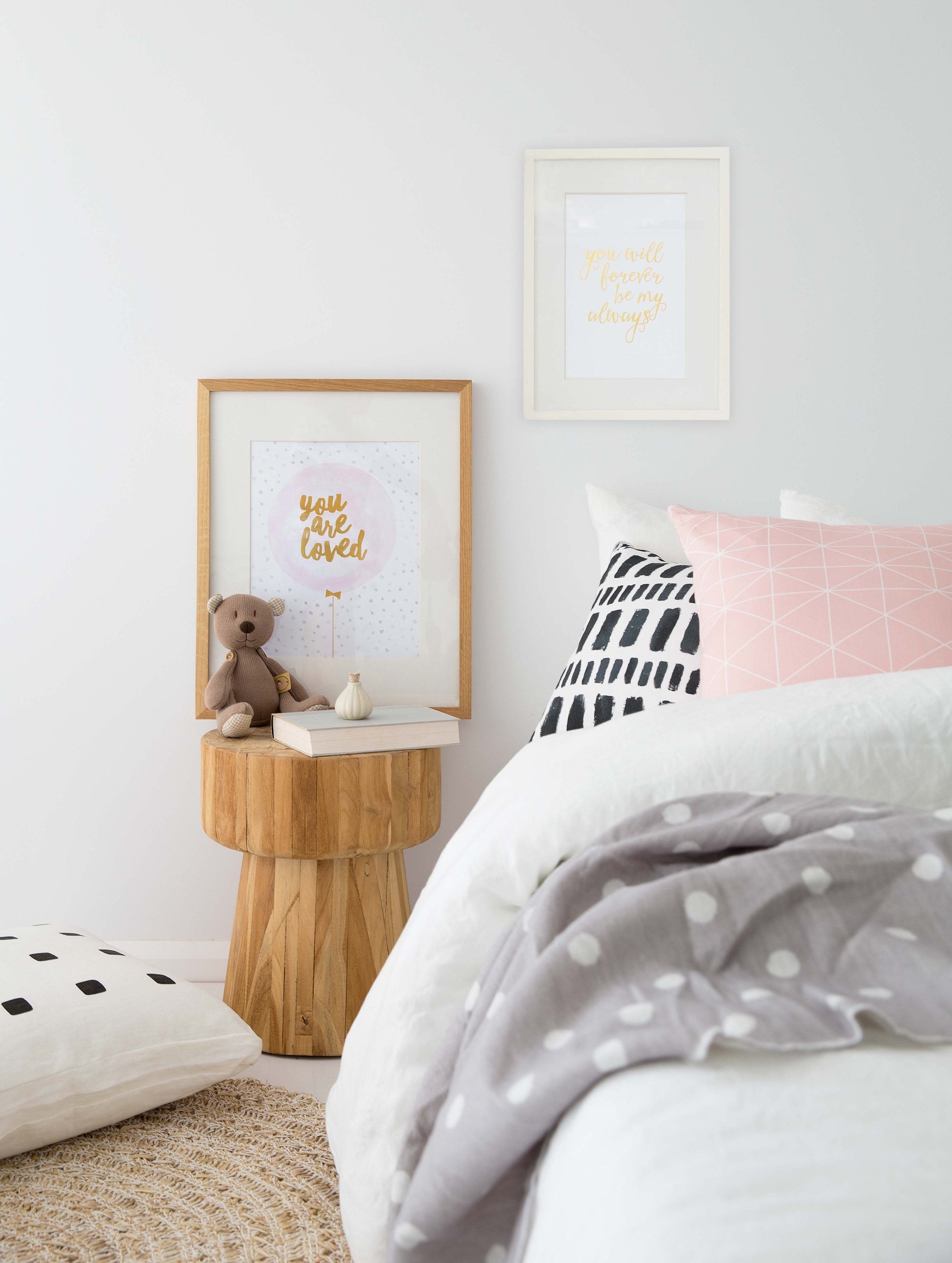 Natural teak side table styled in a cosy bedroom setting, featuring soft textiles, framed artwork, and a plush teddy for a warm and inviting aesthetic