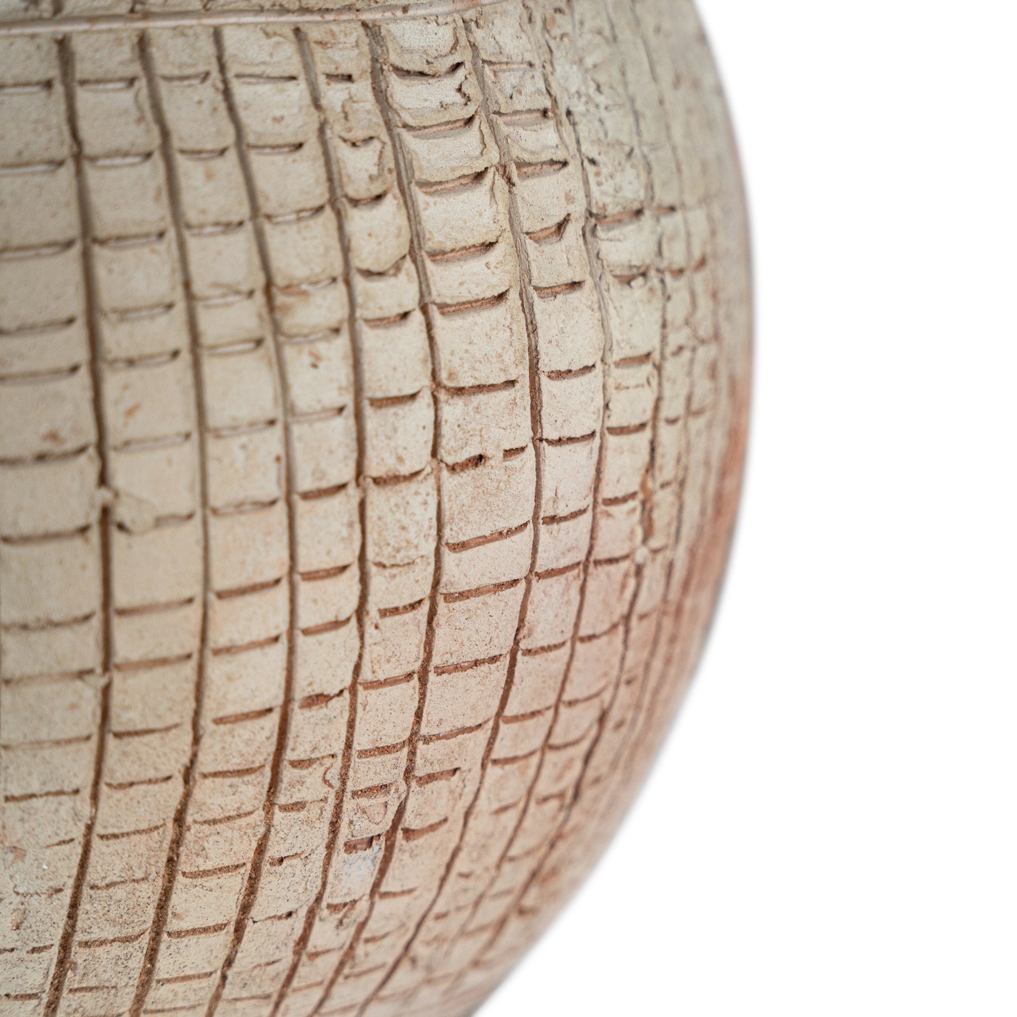 Terracotta table lamp featuring a textured spherical base with intricate grid detailing and a wide conical fabric shade in a neutral tone