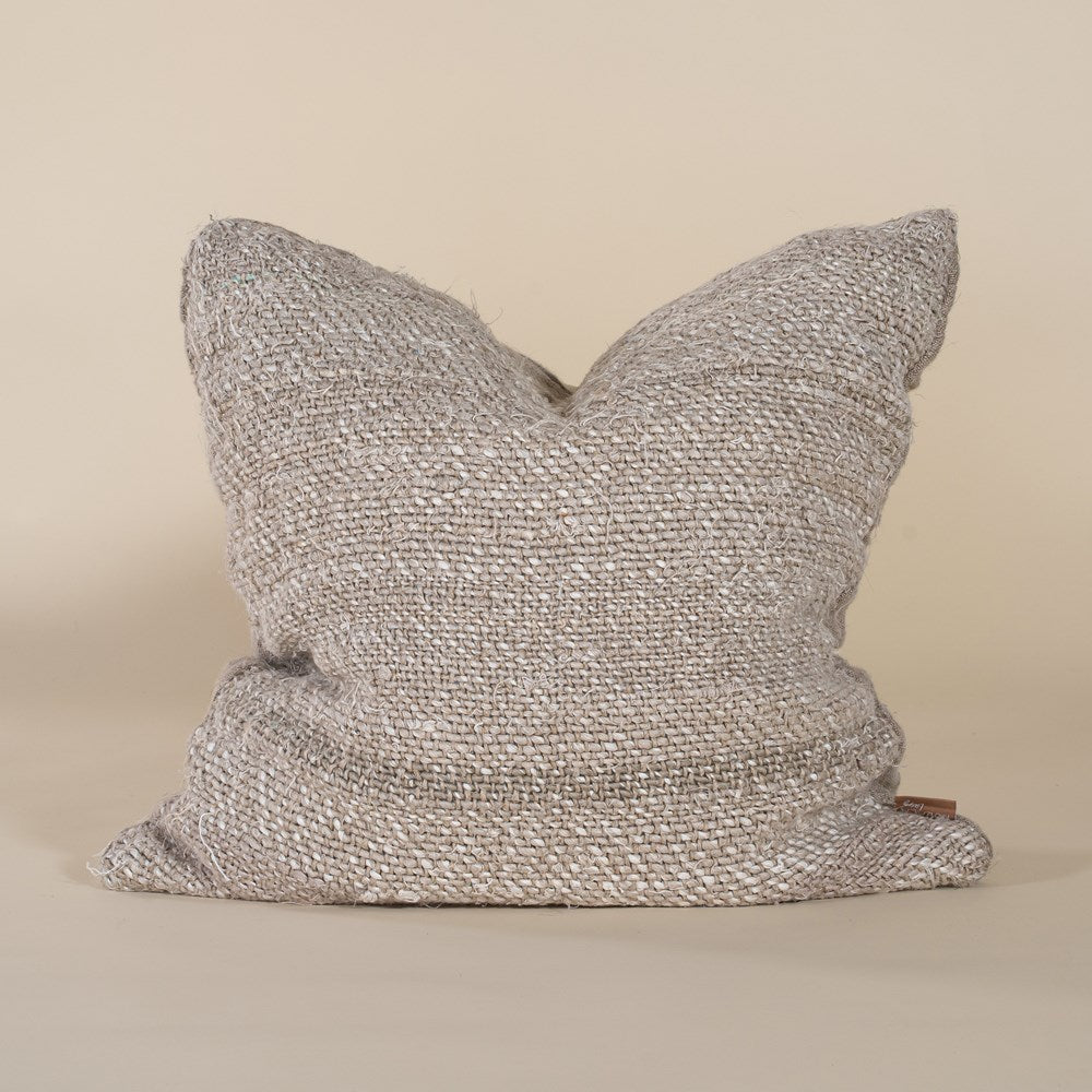 A natural woven cushion with a rich, textured finish, perfect for adding warmth and organic elegance to any sofa or bed. Handcrafted for a timeless aesthetic